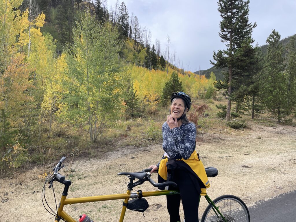 Fall leaves and smiling while holding onto tandem